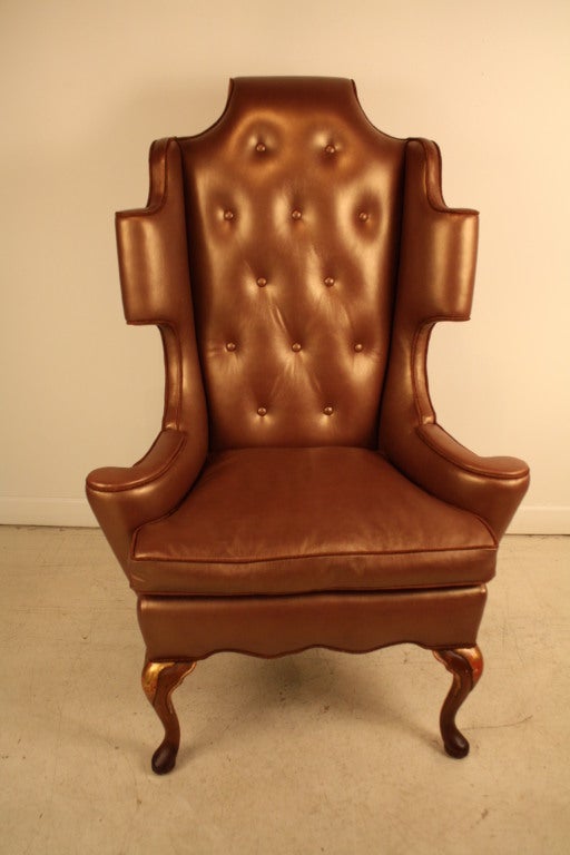 Modernized George II style wing chair newly upholstered in a copper metallic leather with tufted back.  The side and back panel are upholstered in a similar brick color chenille with a faint gold thread echoing the copper and the gold leaf English