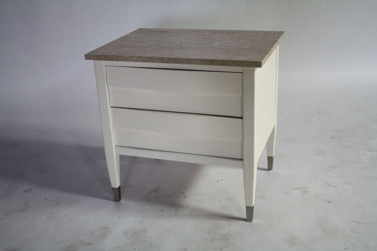 Lovely two drawer nightstand of end table by American of Martinsville newly lacquered in a creamy linen white satin and the original travertine top. Matching dresser available in separate listing.