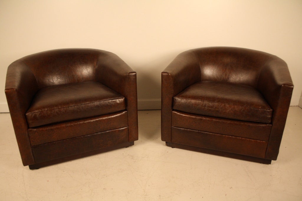 Classic vintage barrel club chairs newly upholstered in a soft, semi-distressed chocolate leather.
