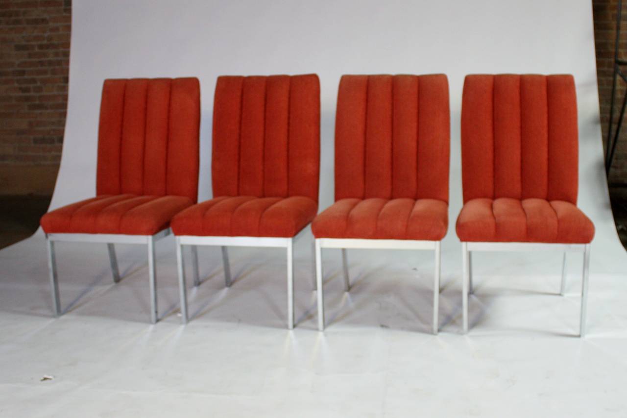 Set of eight Mid-Century Modern dining chairs designed by Milo Baughman for Design Institute of America. Vintage chenille red fabric in channel design upholstery on polished chrome frames. Chrome is clean and chairs are sturdy. Seat height 18.