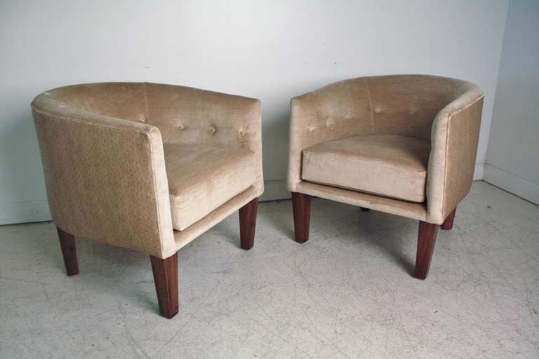 Pair of Kip Stewart tub or barrel chairs for Directional newly upholstered in a warm golden sand color faux ostrich leather back and velvet front.