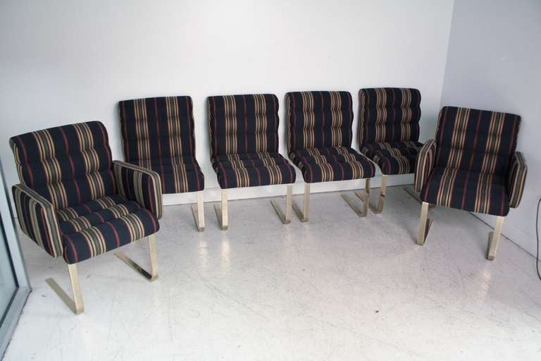 Set of six Pace dining chairs in brass steel sled legs and original channel upholstery striped fabric.  Includes two arm chairs and four side chairs