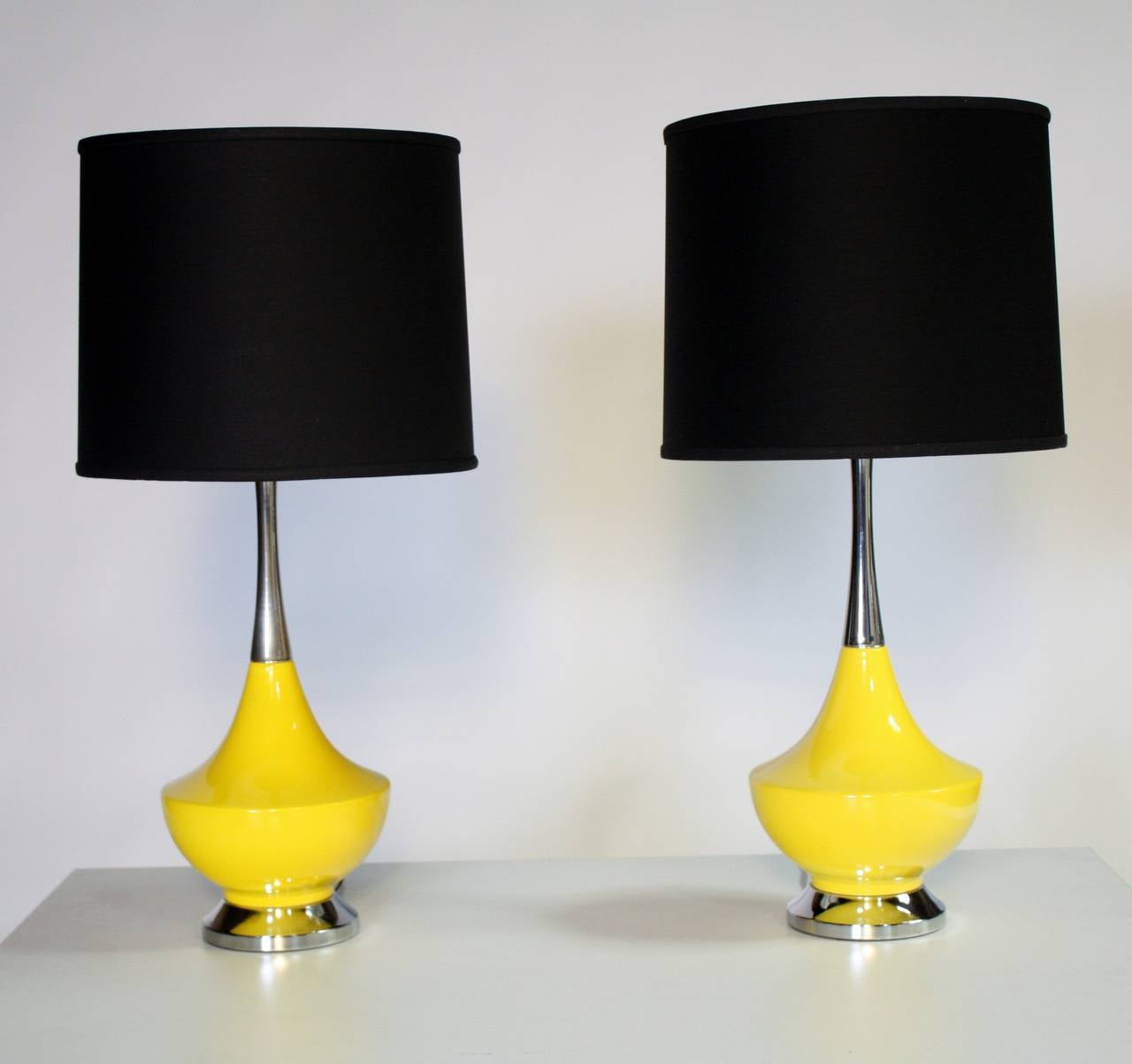 Bright yellow ceramic and chrome genie-shape lamps. Shades not included.