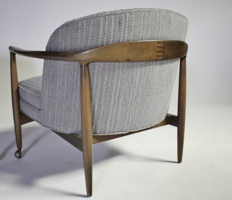 Excellent pair of Mid-Century Modern open armchairs by Ib Kofod-Larsen in original aqua/gray textured fabric and front castors. Walnut is clean and the fabric is in great condition, even the cushions are still very good comfortable.