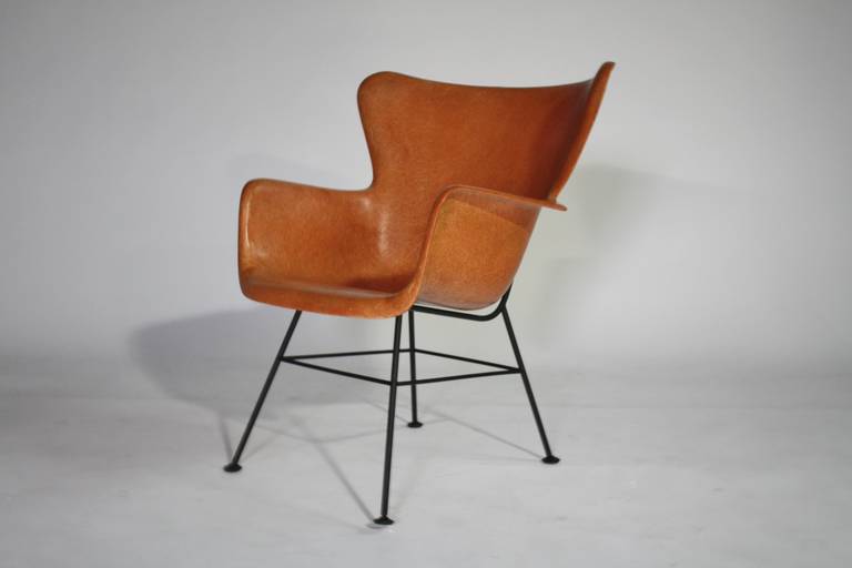 Mid-century modern classic fiberglass shell chair designed by Lawrence Peabody for Selig in salmon and black iron frame and feet.