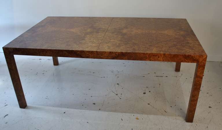 Stunning Parsons-style dining table by Milo Baughman in high gloss lacquered olive burl wood with beautiful book-match grain.  Table extends to 108