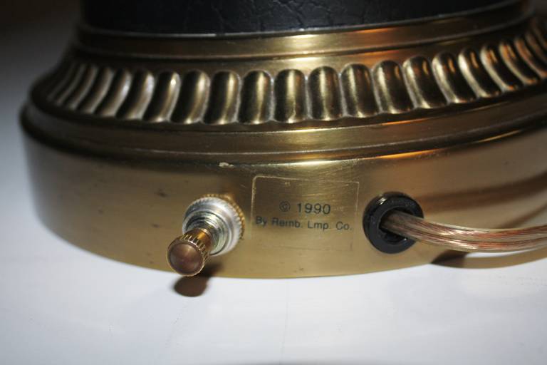Exquisite lamp by Rembrandt depicting brass rams on a black and brass base. Original decorative finial included and a new pleated thread shade measures 12