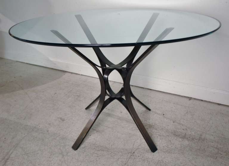 Side or entrance table by Roger Sprunger for Dunbar in bronze with round glass top.