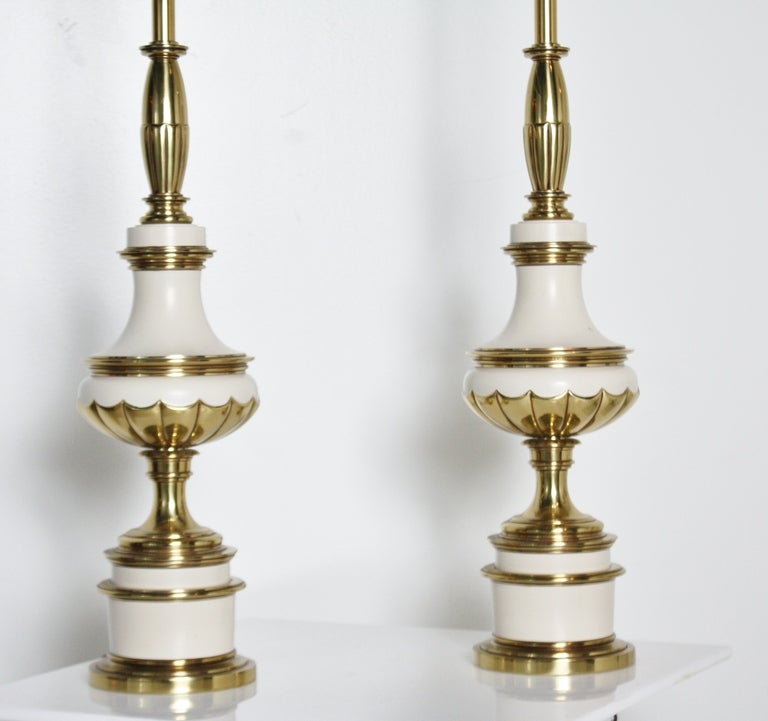 Elegant and heavy pair of Stiffel lamps in brass and ivory in remarkable condition.