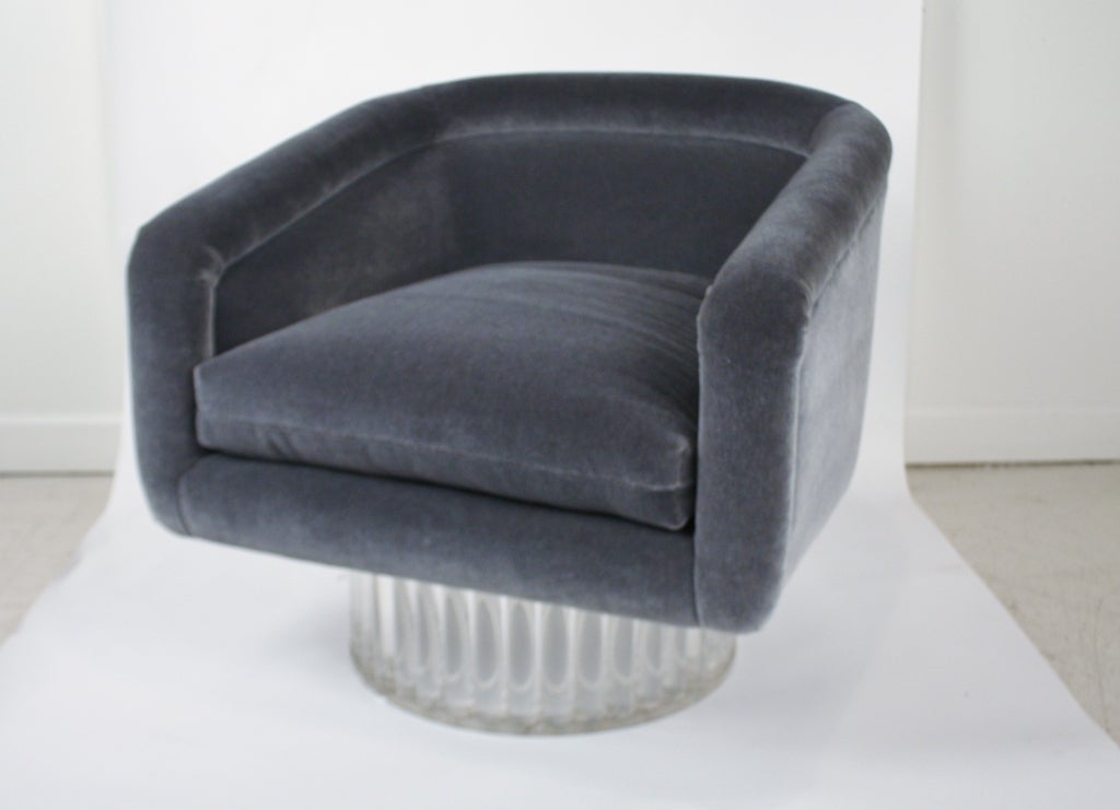 1970s swivel chair on a round pleated column lucite base newly upholstered in a slate blue mohair