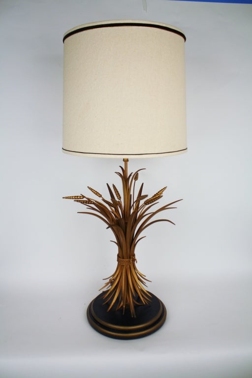 Hollywood Glam sheaf of wheat table lamp on a black and gold base.  A bundle of gilt tole metal stems of wheat are bound by a gold metal rope.  Coco Chanel was captivated by this symbol of plenty and commendable hospitality.  Measurements include
