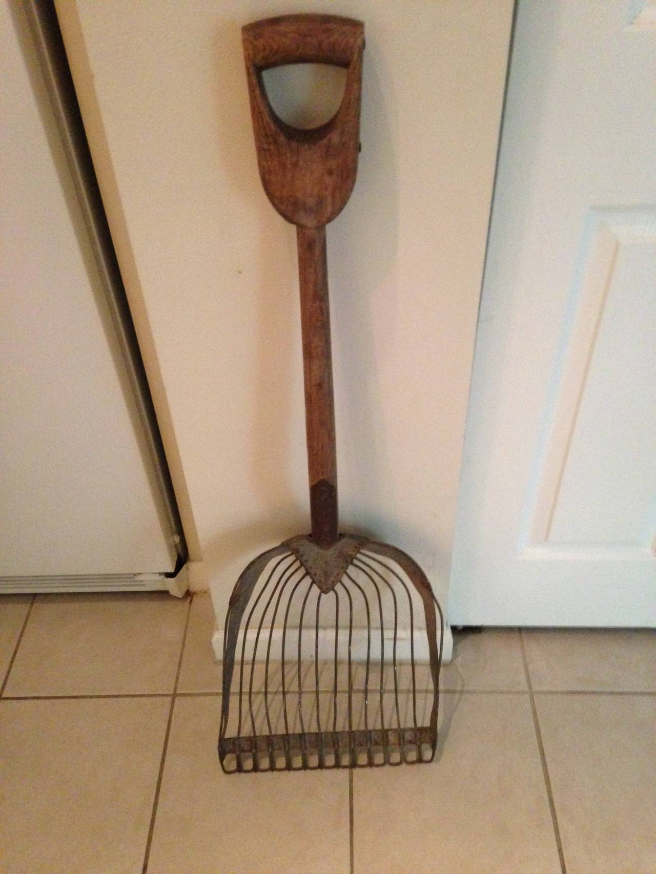 Primitive Maine farm shovel, circa 1890s, with steel tines and frame and wooden handle was used to clean out horse stalls. It has the scoop of a shovel with the lighter-weight, open tines of a fork. Primitive agrarian tool as functional today as it