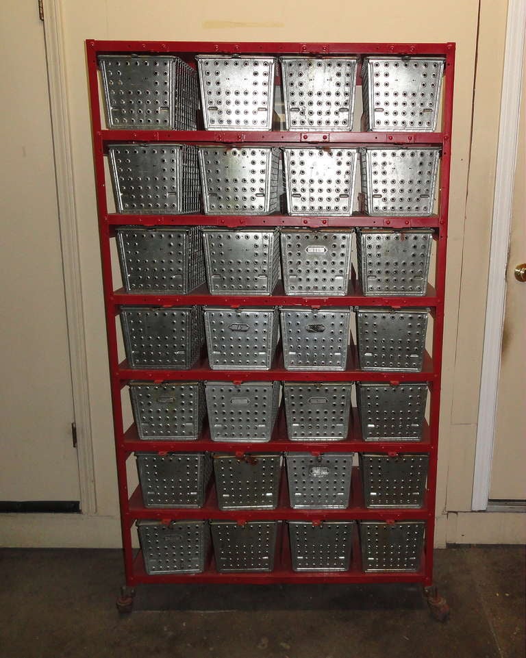 Mid-century swim basket/gym storage locker system. Excellent vintage condition.  28 galvanized steel baskets are all in good shape with no dents or breaks.  No rust. Loop-handle pulls slide baskets smoothly in and out of steel shelving that appears