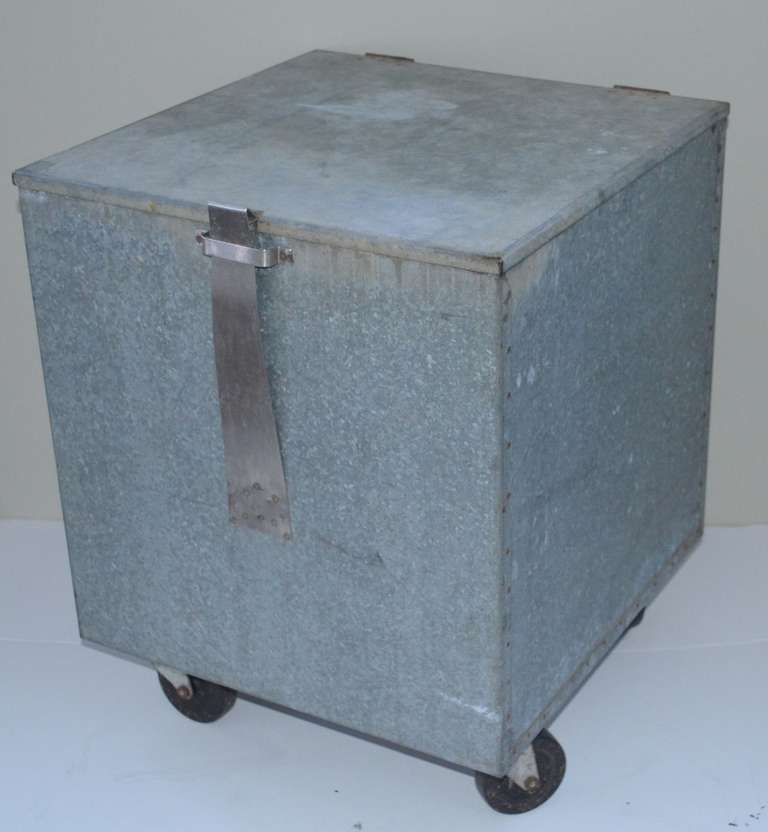 Industrial galvanized steel bin with lid on wheels.  Ideal mobile storage for boots, kids' toys, potted plants, magazines and newspapers.