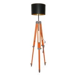 Surveyor Tripod of Orange-Painted Steel as Adjustable Floor Lamp