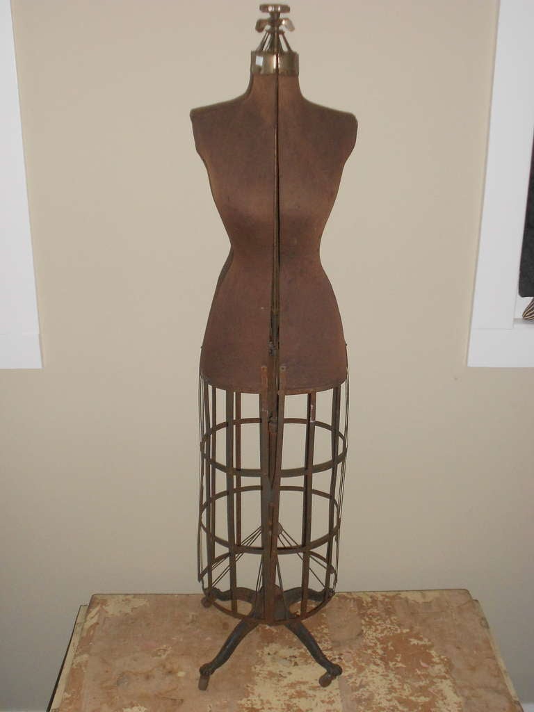 Victorian dress form is a sculptural beauty. Corsets were shaped and fit to its hourglass form. Stands erect upon a collapsible steel frame and is easily wheeled about. 