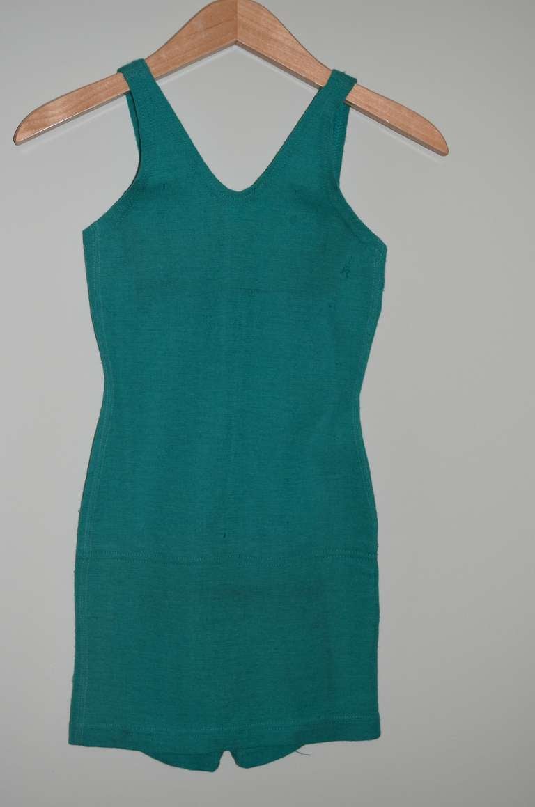 Swim Suit of sea green wool from the 1920s. Back in the day when love of the beach first captivated Americans of all ages and income. Caused a virtual mass migration every summer weekend  to the sea, be it a nearby day trip or week-long vacation.