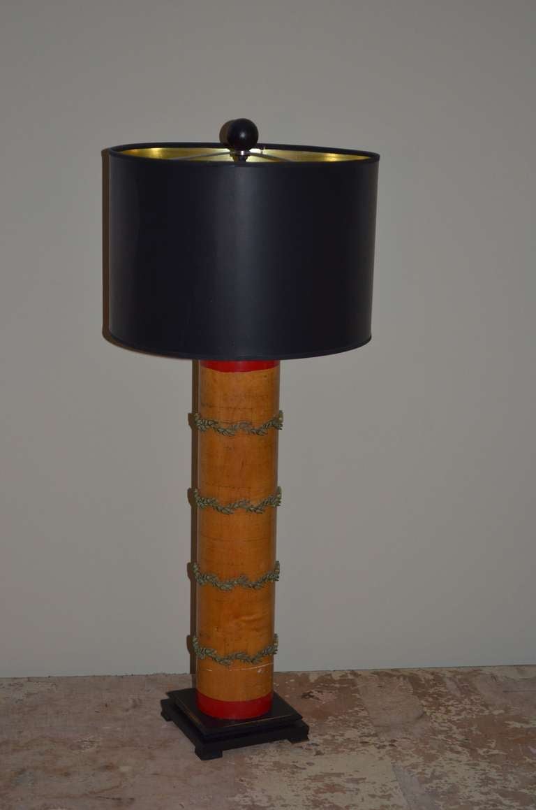 Wallpaper roller with intricate brass filigree was originally used to print wallpaper. Has been made into a table lamp. Sits atop hand-crafted maple base and has been professionally-wired with 3-way socket, 8
