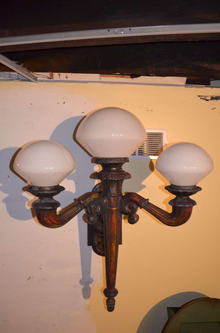 Late 1800s candelabra from a Chicago building has three lights with milk glass globes. Made from 