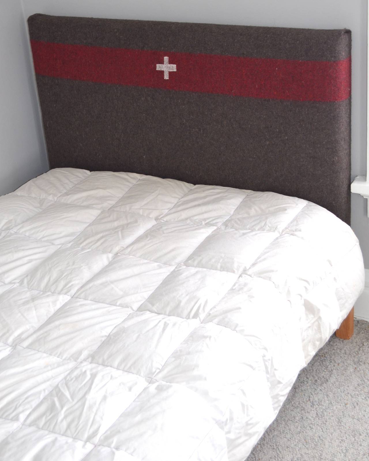 Twin headboard has been upholstered in wool Swiss army blanket from Europe, circa 1960. Headboard is easily installed on the wall behind the bed frame at whatever height is desired.