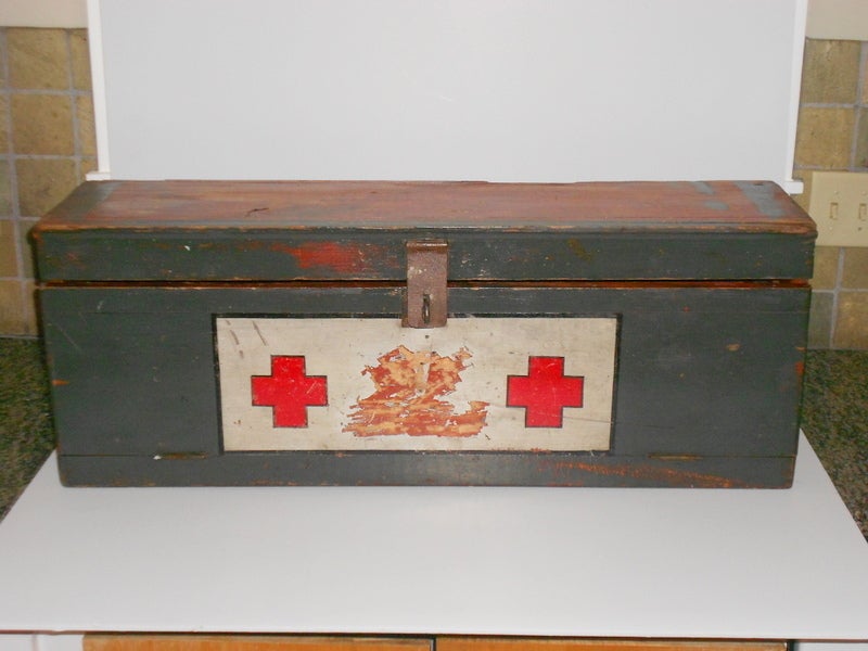 This primitive mobile Red Cross medical chest was handmade from ponderosa pine and hand painted. Front panel is hinged to drop down and create a table for dressings, bandages, etc. Was no doubt used in the field to dress wounds from battle or