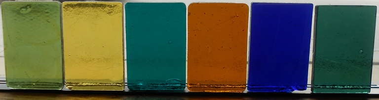 Art Glass Blocks, set of 6 in varied colors, are used to create stained glass windows. Molten glass is poured into forms often with various colors mixed in to create swirls and whorls of design. Air bubbles and cooling cracks are intentionally part