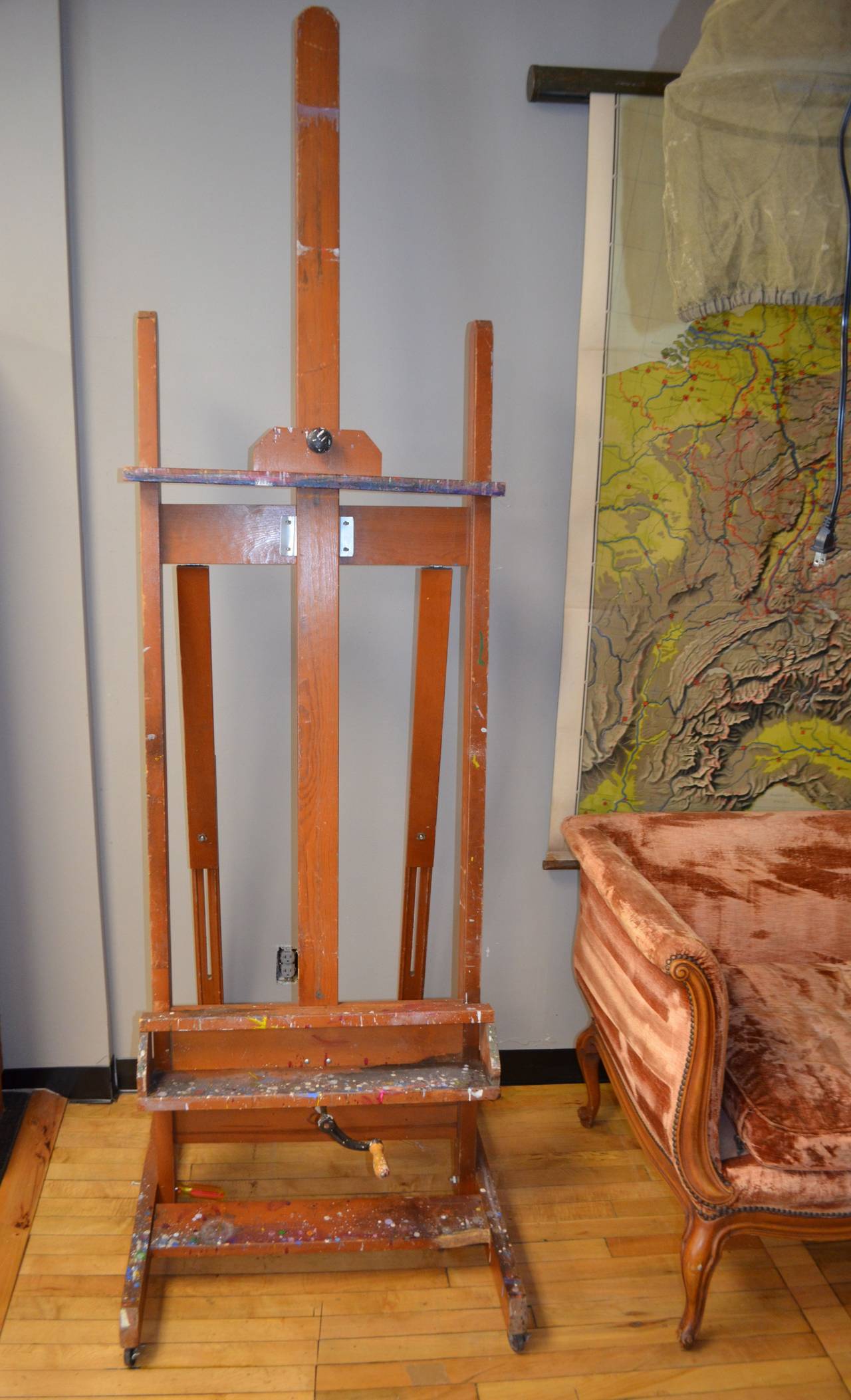 Artist's easel in H-style configuration is an ideal and artsy way to display a flatscreen TV or a recently-acquired painting. Perhaps you'll use it for you own work. The easel has been thoroughly cleaned but the paint spatters remain to complement