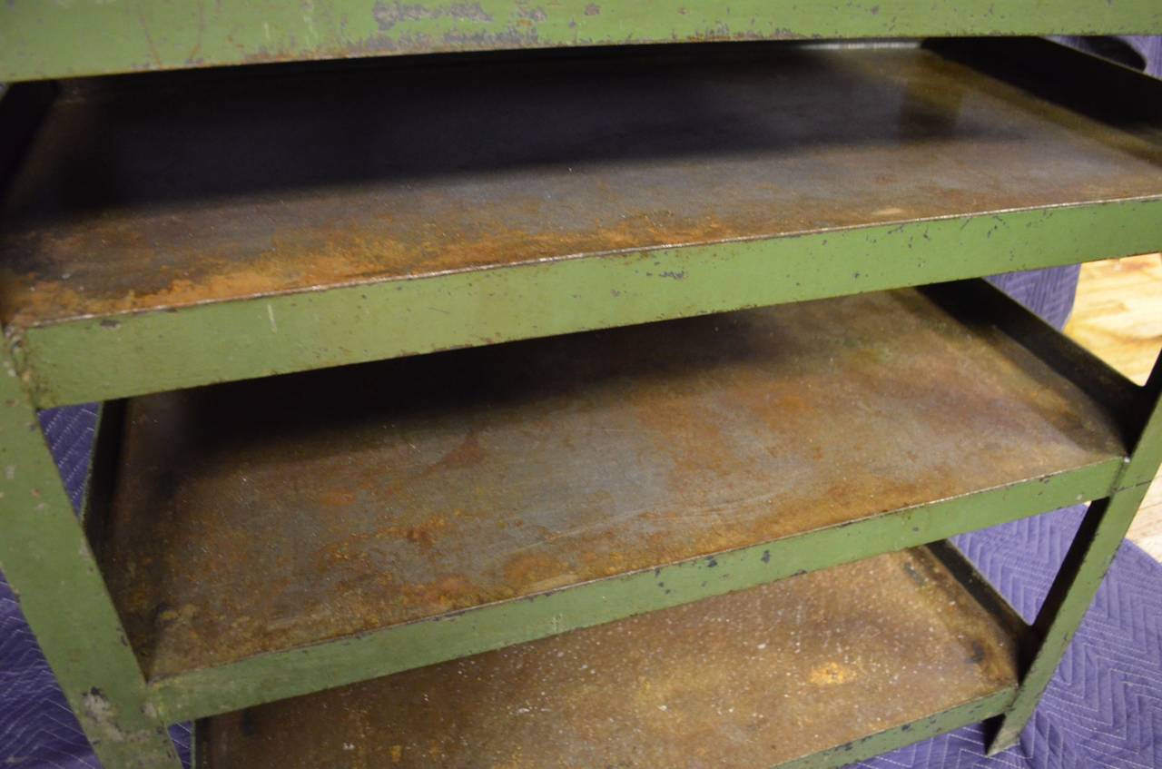 Industrial steel cart in as-found worn green paint once functioned as factory storage. Cart has been cleaned and sealed leaving a rich, rust-flavored patina. Ideal summer bar for patio and deck use. Bring it inside for off-season use in the kitchen.