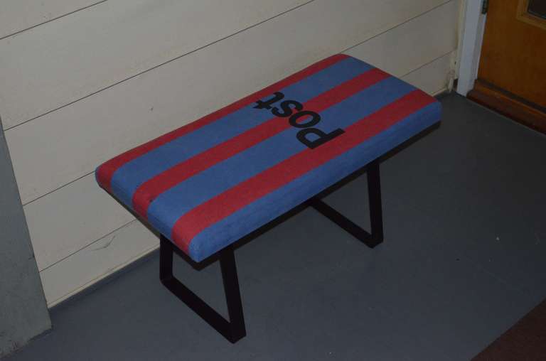 Bench upholstered in vintage French postal bag with steel bracket legs.
