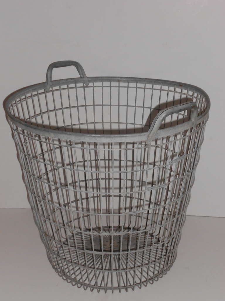 This oversize, galvanized steel basket with handles features a versatility of use with vintage character to boot. For magazines and newspapers at sofa side, towels in the bath, significant potted plants and/or trees, laundry awaiting the wash, kids'