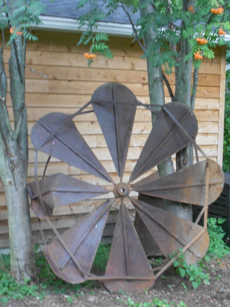 Large-scale, windmill fan blade found on a midwestern farmstead. Forged of cast-iron and steel, this monolithic icon of the early sod-busting homesteads of the Great Plains resonates with the power of harnassed wind. A magnificent piece for an urban
