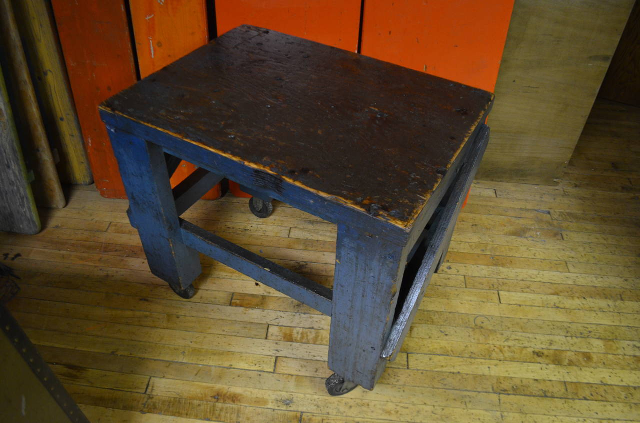 Factory cart on wheels in as-found blue paint and wonderfully worn plywood top has been cleaned and sealed. The working world of the factory revealed in the incidental art and design on that cart's top. (See sidebar photo.) Ready to roll as portable