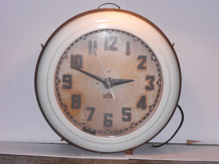 Oversize, electric, gas station clock, no longer functional, was once lit by a circular neon tube mounted inside the pure white lucite rim. Frozen in time at 2:49, this clock has a commanding presence with its large schoolhouse numbers, white