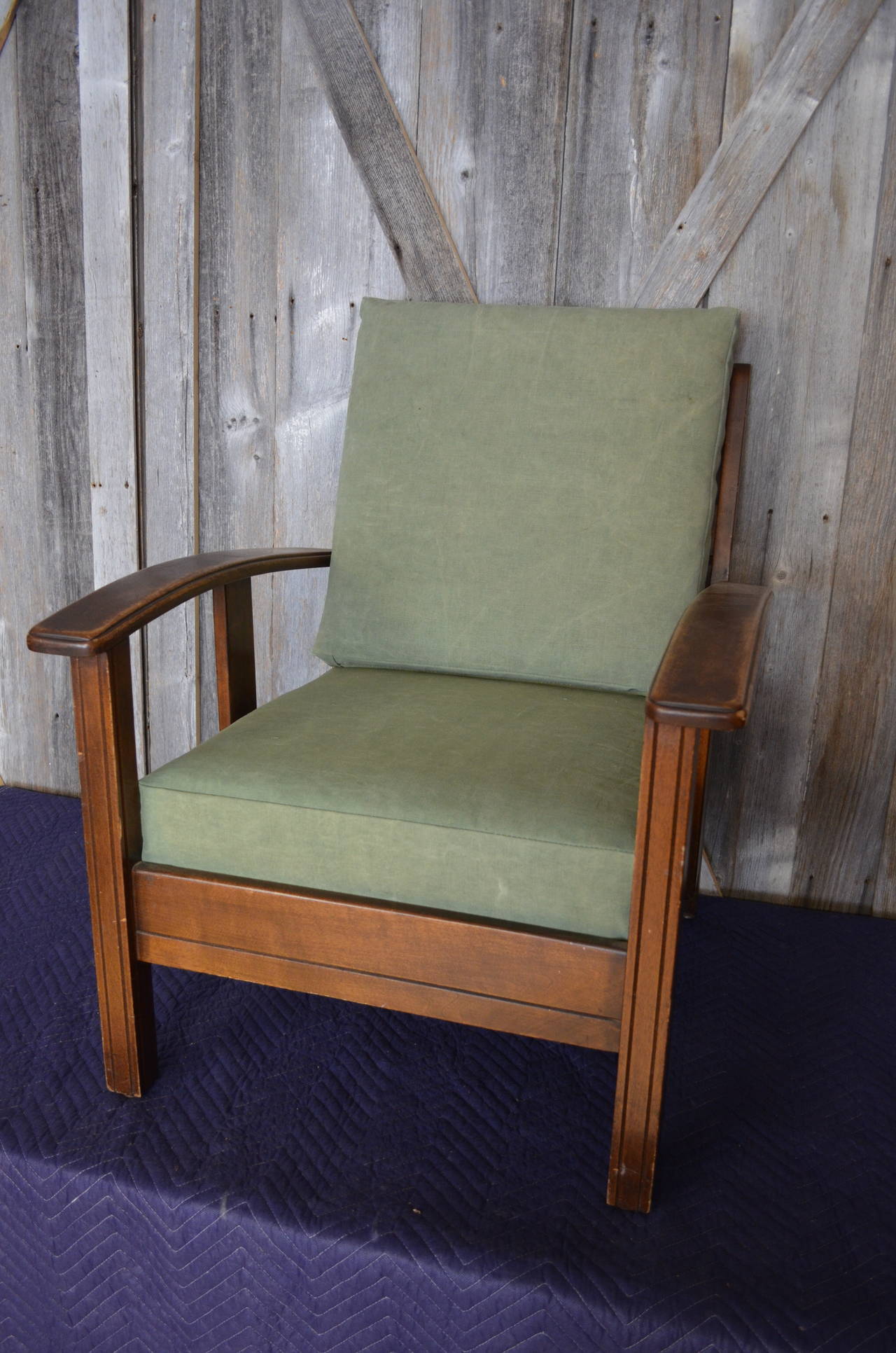Wooden armchair with newly-upholstered cushions of vintage canvas.