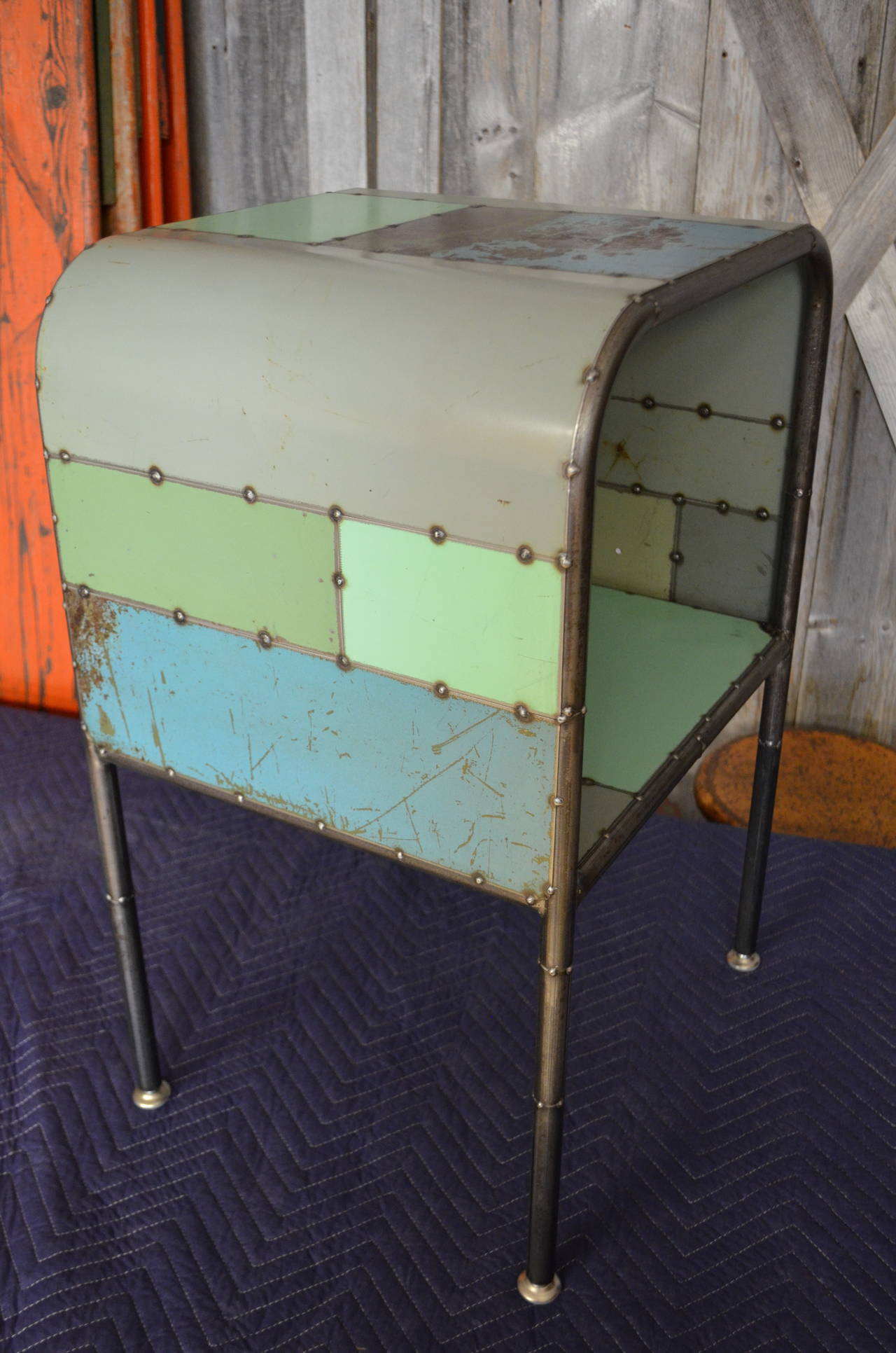 Introducing an original "unearthed" design: Beside table of locally-sourced reclaimed steel. Two shelves and adjustable level feet. Always in similar earth-and-sky colorations (but uniquely yours based on what is available). Price listed