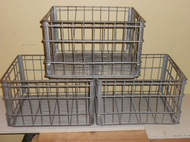 These galvanized steel milk crates are offered in a set of three for $25 each or $75 total. They are from the 1940s, used to ship bottled milk from plant to grocery stores. They are in excellent condition, have been sandblasted to remove any rust,