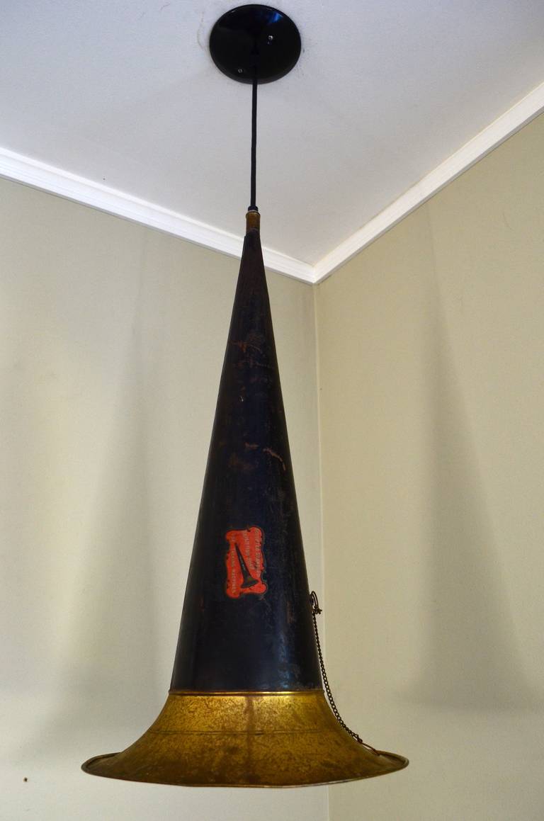 1920s gramophone horn as pendant light. Casts a rich cone of light for a reading corner or for ambiance in living room space. Length of drop from ceiling is adjustable. Professionally wired with UL-approved components including grounded porcelain