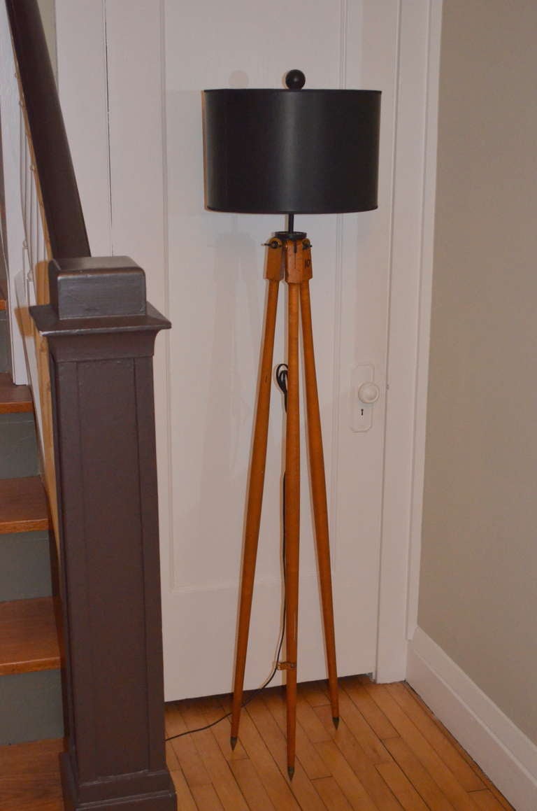 Surveyor Tripod as Floor Lamp with turned wooden maple legs, steel tips and solid brass fittings. Hand marked with the number 10 for field reference. Professionally wired with 10-foot black cord, 3-way socket (150-watt maximum), 8
