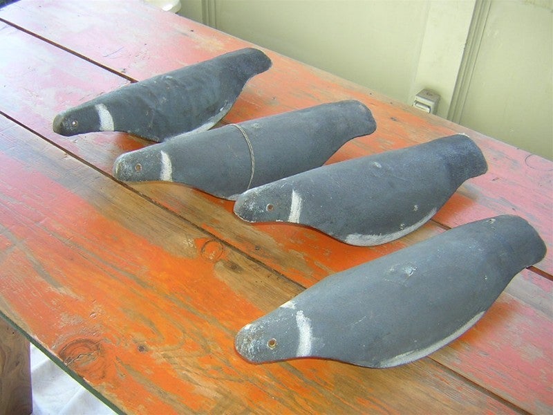 Vintage canvas passenger pigeon decoys that now serve as one-of-a-kind minimalist sculptures in muted grays. Patented information noted on underside states: Max Baker, Pigeon Decoy, patent applied for.