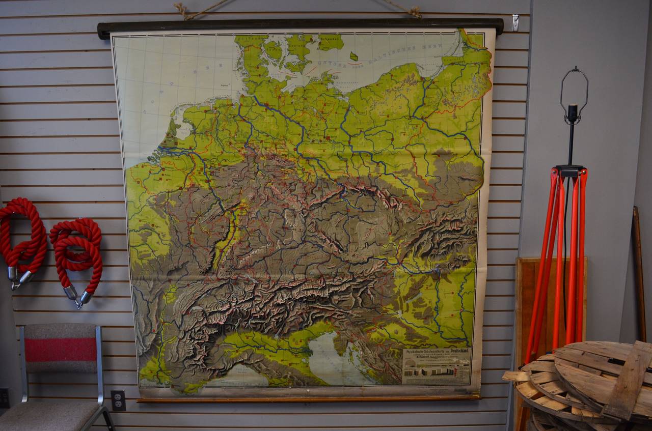Classroom pulldown topographic map of German with contiguous territories of France, Italy and Switzerland. Published in German in the 1920s by A. J. Nystrom & Co. of Chicago, this illustrative rendering of German terrain is so visually arresting