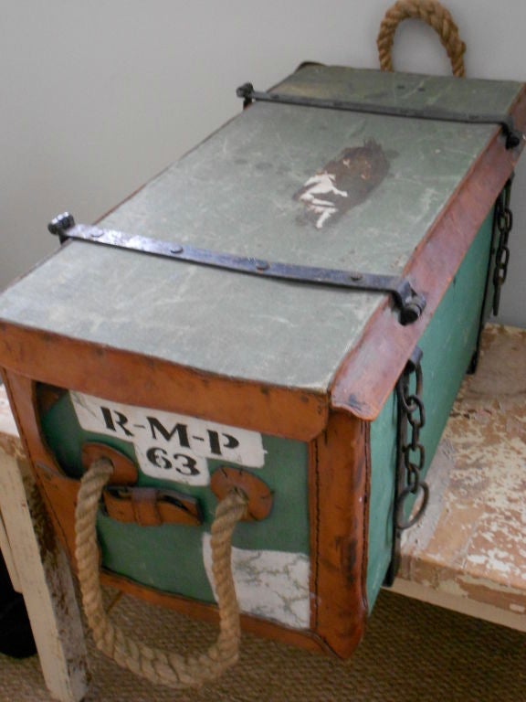 Regimental medical chest (U.S. Army issue) for treatment in the field. Portable chest features thick rope carrying handles, sturdy steel strapping with latch locks. Exterior shell is waterproofed canvas, with painted markings, trimmed in leather and