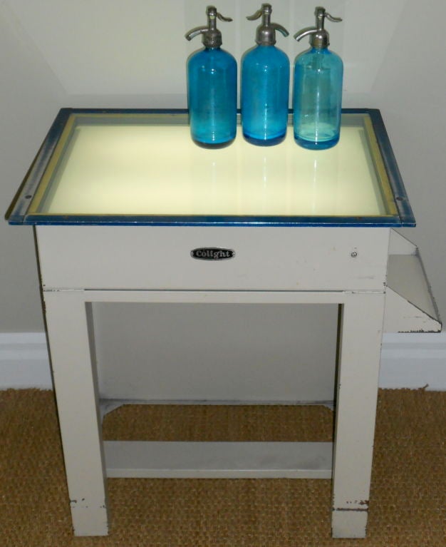 Industrial light table (Colight) with adjustable top upwards to 45 degrees. Features open drawer on right side for small instrument storage. Had multi-purpose usage for industrial, medical, academic, design.  Used for viewing x-rays, slides,