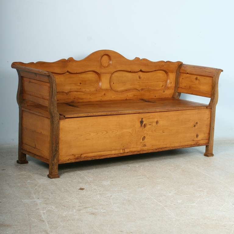 Lovely curves and panels accentuate the back and arms of this pine bench from Romania. It has been given a wax finish which brings out the warmth of the pine. It has been cleaned and restored (including the interior) and is ready for use.
