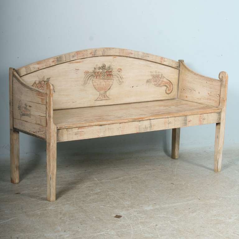 The soft white paint is all original on this lovely Swedish country bench. Please look over the close up photos to appreciate the patina and details of the overflowing vase and cornucopia.