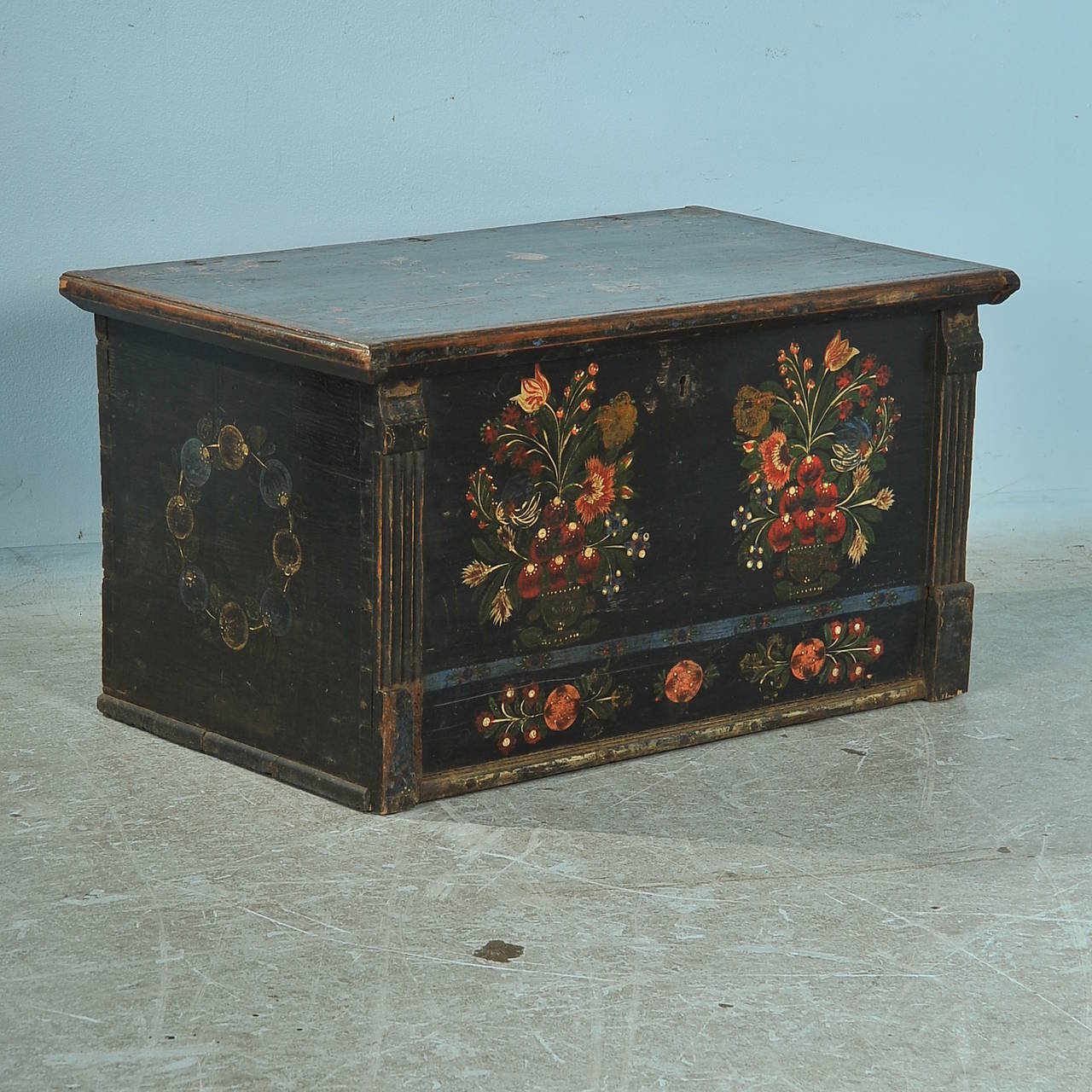 Exceptional paint and exquisite detail are the hallmarks of this lovely painted flat top trunk from Hungary. The coloring is beautiful, with black, green, blue, ocher, burnt orange and deep red details. Note the soft quality of the 