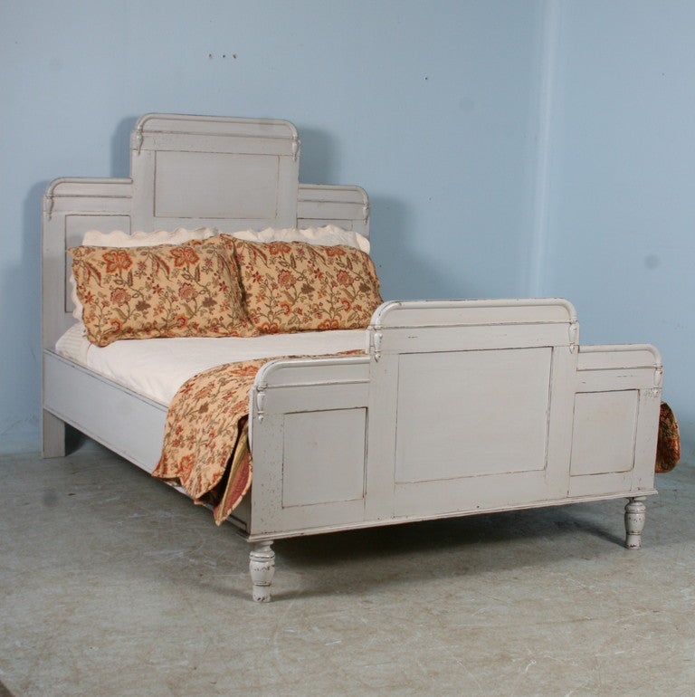 This standard American queen size bed is made from original pines Swedish headboards/footboards from the late 1800's. It has recently been painted and slightly distressed with a Gustavian style white (slightly gray) finish. The side rails are