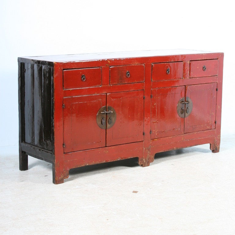 The stunning color is all original on this Chinese sideboard. The deep, rich red is complimented by areas where the paint has worn off through many years of use, revealing the natural wood below. This creates a depth and lends more character to the