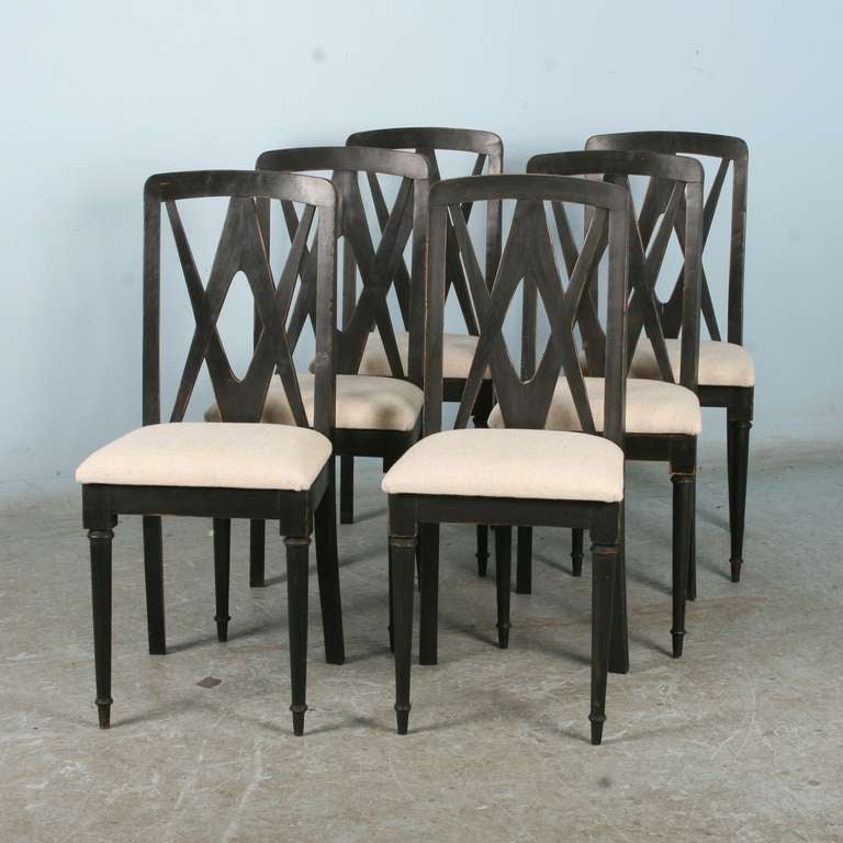 This wonderful set of 6 matching dining chairs or side chairs originate from Denmark, early 1900's. They have been given a new black pained/distressed finish, which along with the newly upholstered linen seats give them a fresh, updated look. They