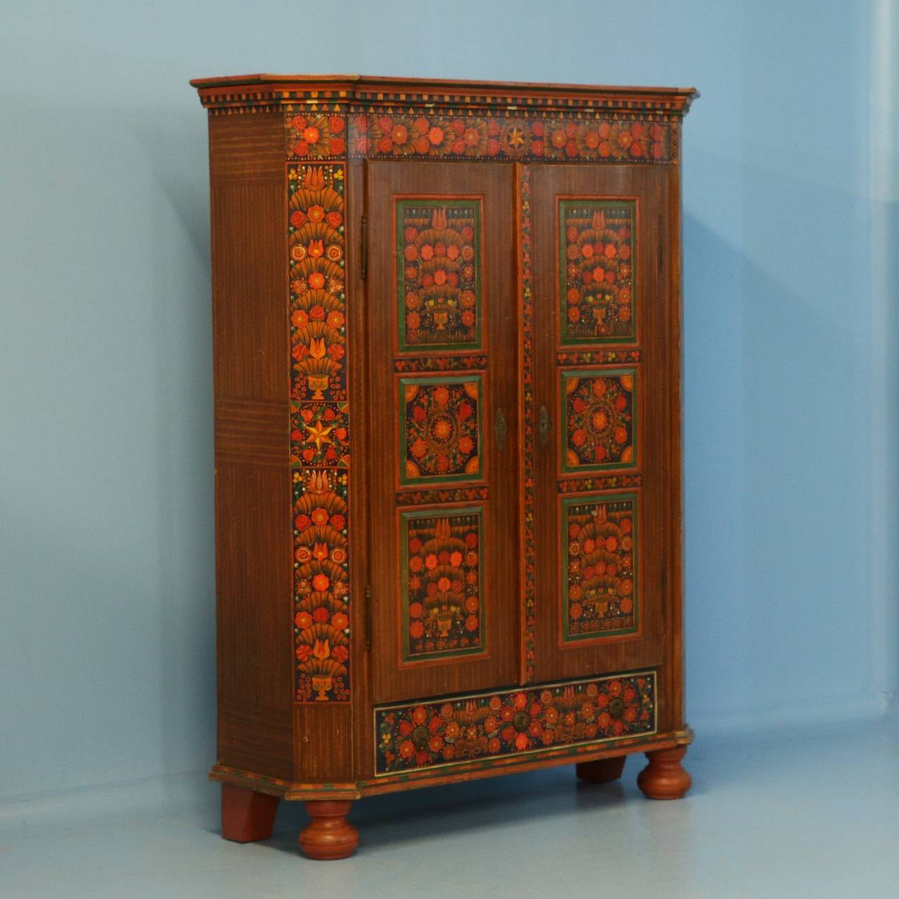 The remarkable paint is all original and extremely clear on this highly decorative armoire. The vibrant paint colors and floral design were traditional folk art style elements during the early 1900's in Hungary. This piece is in exceptional