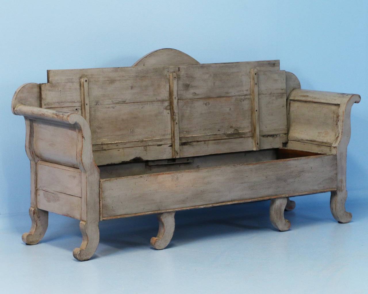 Lovely curves and color define this graceful bench from Sweden. The Karl Johan design is revealed in the graceful curves of the arms, back and even feet. Note the close up photos to appreciated the lovely grey distressed finish complimenting the